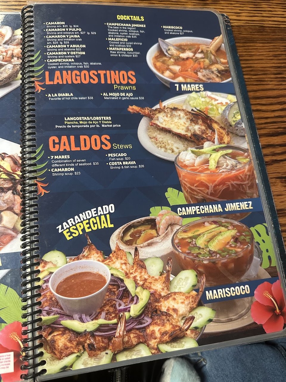 Printed menu with burritos and stews.